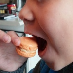 Action pose by nephew as he pretends to eat the salted caramel macaron